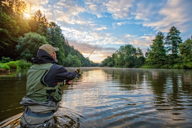 man fishing on the river
